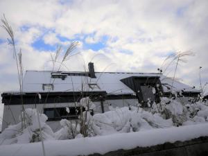 a building with snow in front of it at Apartmán Sychrova in Žďár nad Sázavou