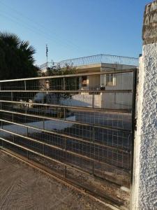 a metal fence in front of a building at Cozy Rodas House 2 in Politika +3 photos