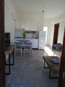 a kitchen with a blue table in a room at Cozy Rodas House 2 in Politika