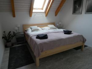 a bedroom with a bed with two hats on it at Apartmán Sychrova in Žďár nad Sázavou