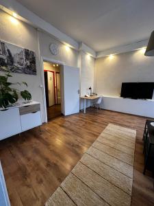 an empty living room with a television and a table at Family Apartment near Kadriorg Swan Pond in Tallinn