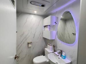 uma casa de banho branca com um lavatório e um espelho em Pet Friendly 305 em Suncheon