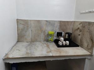 a counter top with a coffee maker on it at Naari home stay in Mathura
