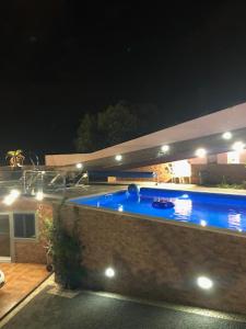 a swimming pool in a backyard at night at Berço Funchal in Funchal