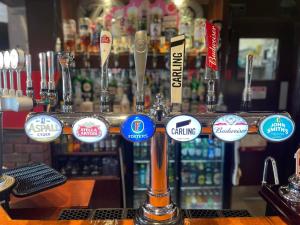 a bar with a bunch of stickers on a bar at 192, Two bed newly refurbished chalet on Sund0wner Holiday Park - Sleeps 5, pet friendly - Includes electricity, bed linen and towels - Entertainment options close by in Hemsby +9 photos