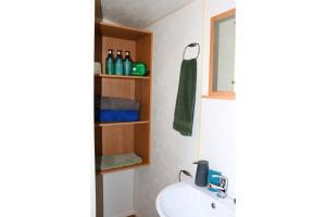 a bathroom with a sink and a mirror at 6-8 sleeper caravan Trecco Bay essentials included in Porthcawl