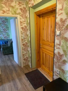 a room with a wooden door and a mirror at Jalaka, Nice 2-bedroom apartment - 1 big bed - 2 single bed in Tartu