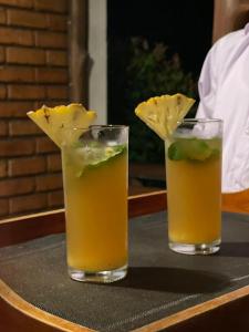 two cocktails sitting on a table with lime and mustard at The Mastodon Valley Safari Resort in Udawalawe