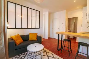 a living room with a couch and a table at Appartement cosy balcon Hypercentre in Manosque