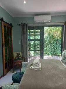 a bedroom with a bed and a sliding glass door at Lucano 1 Stellenbosch in Stellenbosch