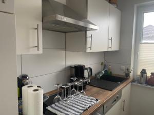 cocina con armarios blancos y encimera en NatureCamp Cuxhaven en Cuxhaven