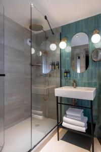 a bathroom with a sink and a shower at Hôtel Maxim Opéra in Paris