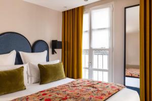 une chambre d'hôtel avec un lit et une fenêtre dans l'établissement Hôtel Maxim Opéra, à Paris