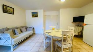 ein Wohnzimmer mit Sofa und Tisch in der Unterkunft Villa en plein centre du village, de plain pied et rénovée en 2008 in Saint-Martin-de-Ré + 1 Foto