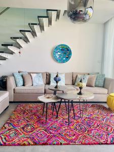 un salon avec un canapé et un tapis dans l'établissement Premium HOME: Bungalow-Apartment mit Rooftop nahe Golfclub & SPA, à Ayios Yeoryios