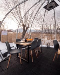 a dining room with a table and chairs in a tent at Glamp In Style Pods Resort in Bran