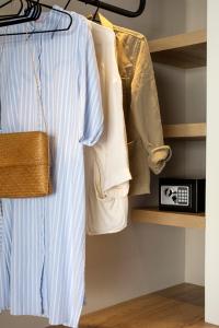 a closet with a shirt and a purse on a shelf at Theros Estate in Amfilochía