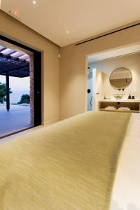 a room with a bed with a view of the ocean at Theros Estate in Amfilochía