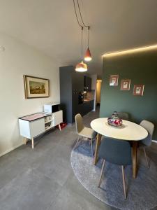 - un salon avec une table et des chaises dans l'établissement Alloggio con Terrazza, à Villanova Mondovì