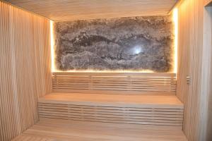 a sauna with a wooden floor and a wall with a painting at Dosso Dossi Hotels & SPA Golden Horn in Istanbul