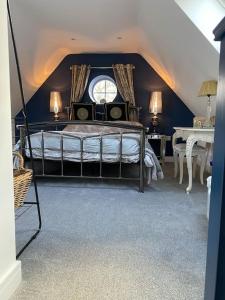 a bedroom with a bed with a window and a table at Elegant home near Stratford upon avon in Alcester