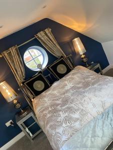 a bedroom with a bed with two lamps and a window at Elegant home near Stratford upon avon in Alcester