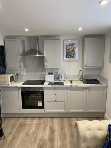 a kitchen with white cabinets and a counter top at Elegant home near Stratford upon avon in Alcester