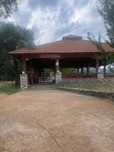 a pavilion with a bench in a park at Leon & Ema in Donji Murići