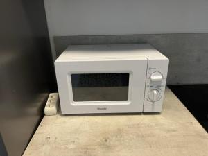 a microwave oven sitting on top of a counter at Appartement Cap d'Agde, 3 pièces, 4 personnes - FR-1-749-9 in Cap d'Agde