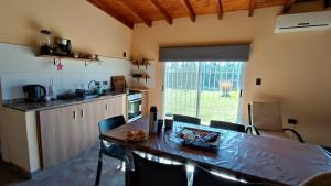 a kitchen with a table and chairs in a room at LA QUINTA DE LOLI in San Pedro