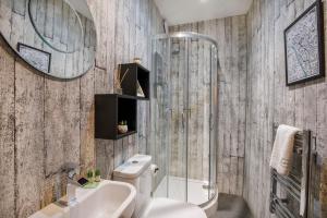 a bathroom with a shower and a toilet and a sink at Clearly Apartments Bootham York in York