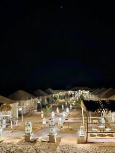 a group of lights in a desert at night at Sahara Luxury Camp in Merzouga