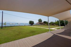 a view of the ocean from a house balcony at Greek Dream Residence in Áyios Andréas Messinias