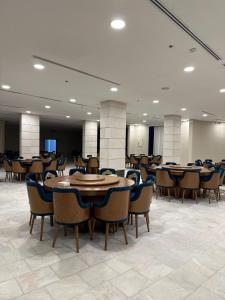 a large room with tables and chairs in a building at Vista Hotel Haql in Al Humaizah +74 photos