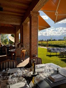 a restaurant with a table with wine glasses on it at Andeluna Winery Lodge in Tupungato