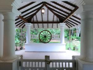 a large pavilion with a wooden roof and a wheel at Anncyl1857 in Veyangoda