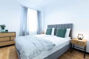 a bedroom with a large bed and a window at Slow River Apartment in Nowe Miasto Lubawskie