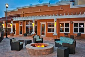 a patio with chairs and a fire pit in front of a building at Residence Inn New Brunswick Tower Center Blvd. in East Brunswick