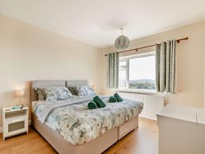 a bedroom with a large bed and a window at 2 Bed in Paignton 92055 in Paignton