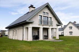 a large white house with a black roof at Luxury Lodge-Lough Erne Resort in Ballycassidy