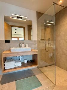 a bathroom with a sink and a shower at Schneiderhof, Urlaub auf dem Bauernhof in Ridanna
