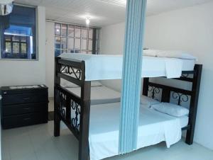 a room with two bunk beds and a mirror at Apartamento de verano a orillas de la Represa de Prado 1 de 2 in Boquerón de Tena