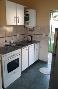 a kitchen with a white stove and a sink at Casa Passiflora II in Villa Elisa