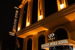 a building with a sign for a golden river hotel at Golden River Hotel By Continent in Arnavutköy