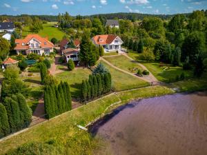 an aerial view of a house with a river at Domki Kątno in Stare Jabłonki