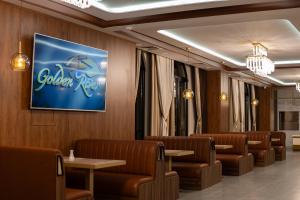 a waiting room with chairs and a sign on the wall at Golden River Hotel By Continent in Arnavutköy