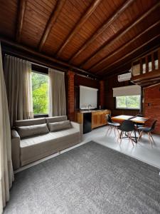 a living room with a couch and a table at Pousada Vale Das Águias in Jaguaruna