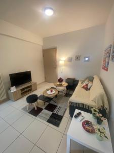 a living room with a bed and a tv at Athina’s apartment in Athens