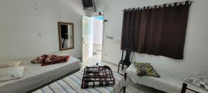 a room with two beds and a window and a mirror at Recanto Azul in Aparecida +58 photos