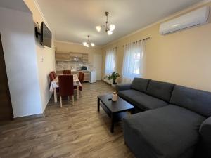 a living room with a couch and a table at Borostyán Vendégház in Verpelét